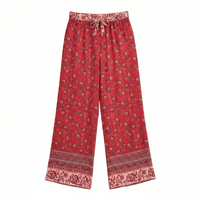 Crimson Meadow boho wide leg pants with functional side pockets, a high waist drawstring waistband, lightweight rayon fabric, and a flowy red floral palazzo silhouette featuring a floral and butterfly-inspired print.