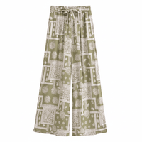Olive mosaic boho wide leg pants with a high waist drawstring waistband, vintage patchwork print, and flowy palazzo silhouette.