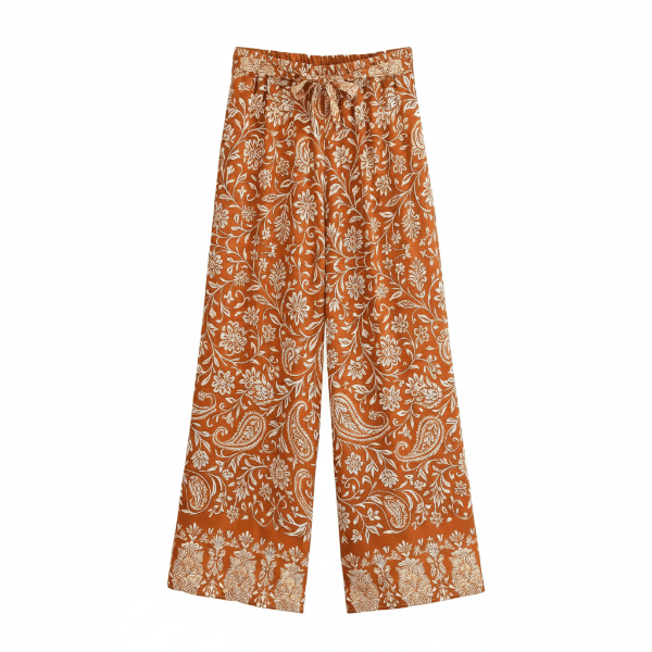 Rust paisley boho wide leg pants with functional side pockets, a high waist drawstring waistband, and a flowy palazzo silhouette.