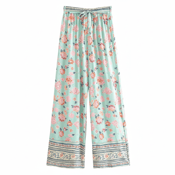 Seafoam Bloom boho wide leg pants with functional side pockets, a high waist drawstring waistband, lightweight rayon fabric, and a flowy floral palazzo silhouette with a seafoam floral print.