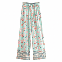 Seafoam Bloom boho wide leg pants with functional side pockets, a high waist drawstring waistband, lightweight rayon fabric, and a flowy floral palazzo silhouette with a seafoam floral print.