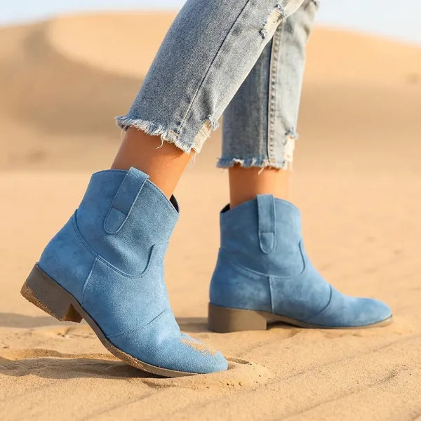 Blue boho ankle boots featuring a vintage-inspired distressed finish, low western heels, and pointed toe design.