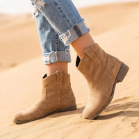 Brown vintage western ankle boots for women with a distressed-look finish, pointed toes, and relaxed slouchy silhouette.